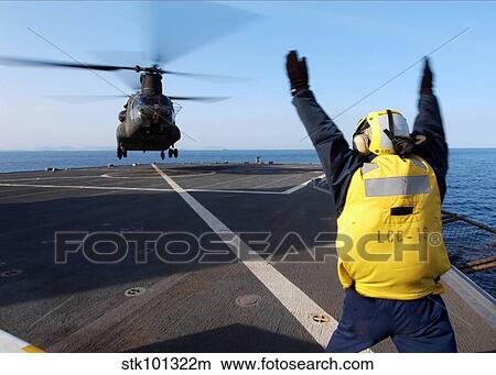 Boatswain's Mate signals to a CH-47 Chinook helicopter. View Large Photo Image Picture - Boatswain's Mate signals to a CH-47 Chinook helicopter.. Fotosearch