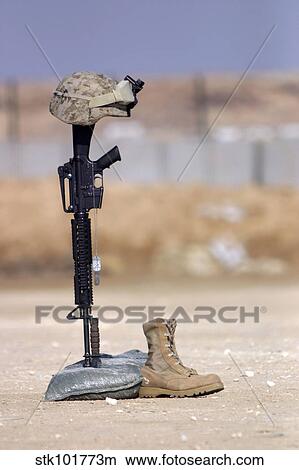 Boots, rifle, dog tags, and protective helmet stand in solitude to honor fallen soldiers. View Large Photo Image Picture - Boots, rifle, dog tags, and protective helmet stand in solitude to honor fallen soldiers.. Fotosearch