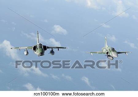 Brazilian Air Force A-1M (left) and F-5EM taken in-flight during Exercise Cruzex. View Large Photo Image Picture - Brazilian Air Force A-1M (left) and F-5EM taken in-flight during Exercise Cruzex.. Fotosearch