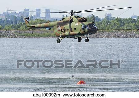 Bulgarian Air Force Mi-17 taking water with Bambi Bucket. View Large Photo Image Picture - Bulgarian Air Force Mi-17 taking water with Bambi Bucket.. Fotosearch