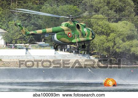 Picture - Bulgarian Air Force Mi-17 taking water with Bambi Bucket.. Fotosearch
