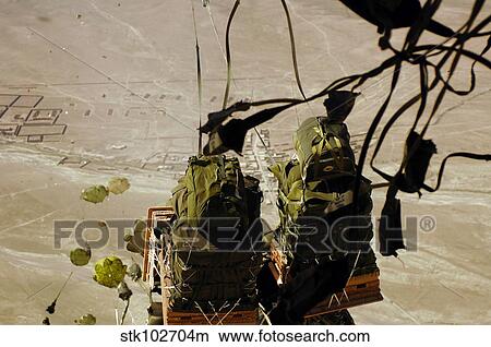 Bundles of humanitarian supplies are dropped from a C-17 Globemaster III. View Large Photo Image Picture - Bundles of humanitarian supplies are dropped from a C-17 Globemaster III.. Fotosearch