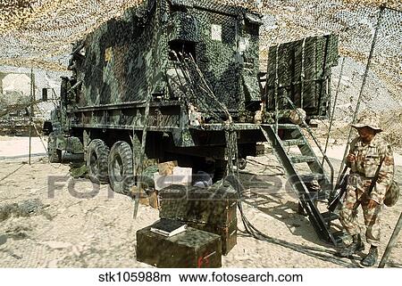 Picture - Camouflage netting covers a cargo truck.. Fotosearch