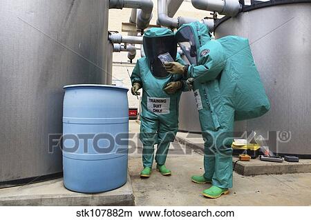 CBRN defense specialists check a barrel for contamination. View Large Photo Image Picture - CBRN defense specialists check a barrel for contamination.. Fotosearch