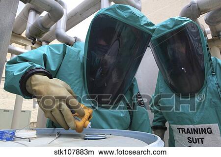 CBRN defense specialists check a barrel for contamination. View Large Photo Image Picture - CBRN defense specialists check a barrel for contamination.. Fotosearch
