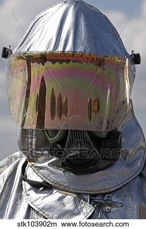 Picture - Close-up view of a firefighter in a fire proximity suit.. Fotosearch