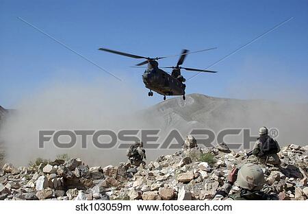 Clouds of dust kicked up by the rotor wash of a CH-47 Chinook helicopter in Afghanistan. View Large Photo Image Picture - Clouds of dust kicked up by the rotor wash of a CH-47 Chinook helicopter in Afghanistan. . Fotosearch