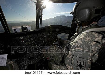 Co-pilot flying a CH-47 Chinook helicopter. View Large Photo Image Picture - Co-pilot flying a CH-47 Chinook helicopter.. Fotosearch
