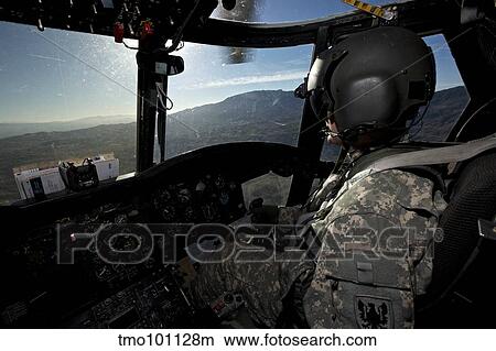 Co-pilot flying a CH-47 Chinook helicopter. View Large Photo Image Picture - Co-pilot flying a CH-47 Chinook helicopter.. Fotosearch