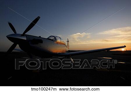 COB Speicher, Iraq - An Iraqi Airforce T-6 Texan trainer aircraft at sunset. View Large Photo Image Picture - COB Speicher, Iraq - An Iraqi Airforce T-6 Texan trainer aircraft at sunset.. Fotosearch