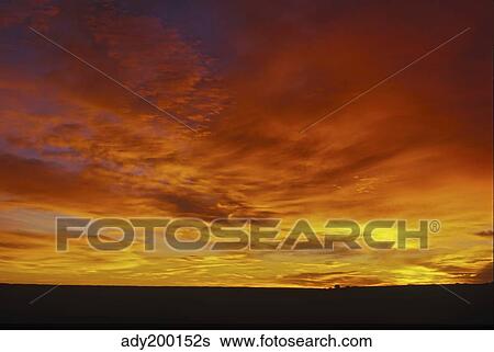 Stock Photograph - Colorful clouds at sunset in Alberta, Canada.. Fotosearch