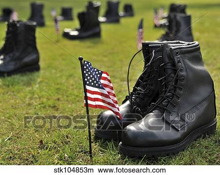 Combat boots are placed in formation representing America's POW/MIA. View Large Photo Image Picture - Combat boots are placed in formation representing America's POW/MIA.. Fotosearch