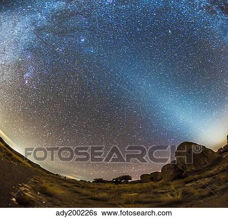 Stock Photograph - Comet Lovejoy and zodiacal light in City of Rocks State Park, New Mexico.. Fotosearch