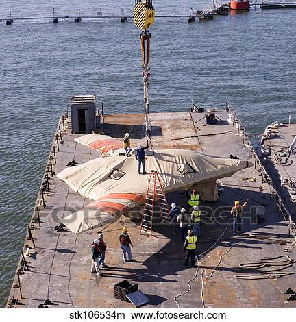 Contractors hoist the X-47B Unmanned Combat Air System. View Large Photo Image Picture - Contractors hoist the X-47B Unmanned Combat Air System.. Fotosearch