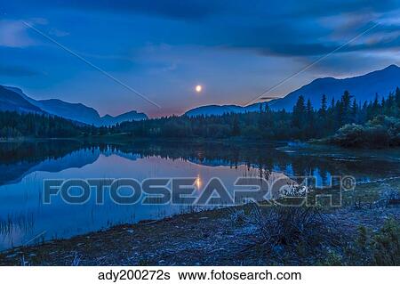 Crescent moon over Middle Lake in Bow Valley Provincial Park, Alberta, Canada. View Large Photo Image Stock Photograph - Crescent moon over Middle Lake in Bow Valley Provincial Park, Alberta, Canada.. Fotosearch