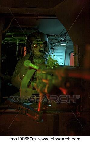 Crew cheif equipped with night vision goggles mans a M240G machine gun. View Large Photo Image Picture - Crew cheif equipped with night vision goggles mans a M240G machine gun.. Fotosearch