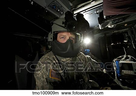 Crew chief in a UH-60 Black hawk helicopter. View Large Photo Image Picture - Crew chief in a UH-60 Black hawk helicopter.. Fotosearch