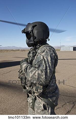 Picture - Crew chief of a CH-47 Chinook stands outside the aircraft.. Fotosearch