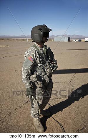 Crew chief of a CH-47 Chinook stands outside the aircraft. View Large Photo Image Picture - Crew chief of a CH-47 Chinook stands outside the aircraft.. Fotosearch