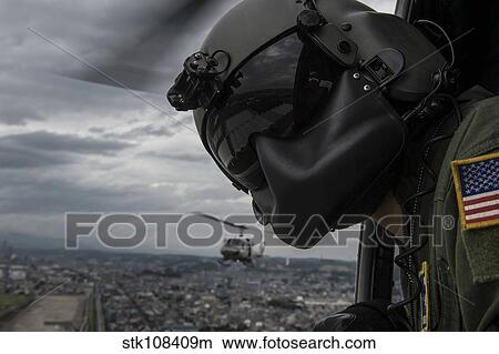 Crew chief scans the area from a UH-1N Huey helicopter. View Large Photo Image Picture - Crew chief scans the area from a UH-1N Huey helicopter.. Fotosearch