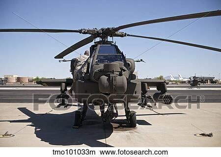 Crew chief working on an AH-64D Apache Longbow. View Large Photo Image Picture - Crew chief working on an AH-64D Apache Longbow.. Fotosearch