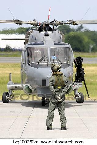 Crewmember stands in front of a Sea Lynx helicopter of the German Navy. View Large Photo Image Picture - Crewmember stands in front of a Sea Lynx helicopter of the German Navy.. Fotosearch
