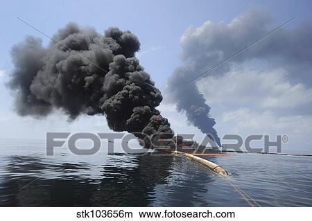 Dark clouds of smoke and fire emerge as oil burns during a controlled fire in the Gulf of Mexico. View Large Photo Image Picture - Dark clouds of smoke and fire emerge as oil burns during a controlled fire in the Gulf of Mexico.. Fotosearch