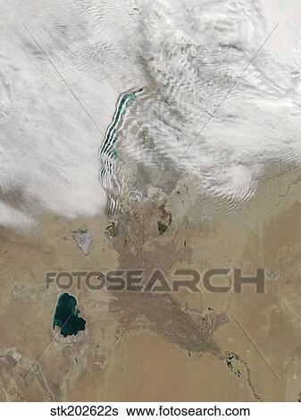 Distinctive lines of clouds stretch out from the shore of the Aral Sea. View Large Photo Image Stock Photograph - Distinctive lines of clouds stretch out from the shore of the Aral Sea.. Fotosearch