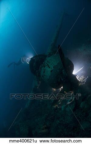 Diver exploring the wreck of a Japanese Navy Seaplane in Palau, Micronesia. View Large Photo Image Stock Photograph - Diver exploring the wreck of a Japanese Navy Seaplane in Palau, Micronesia.. Fotosearch