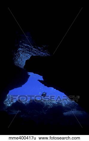 Diver with lights entering a submerged cave, Australia. View Large Photo Image Stock Photograph - Diver with lights entering a submerged cave, Australia.. Fotosearch