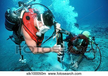 Divers work to repair an undersea cable at the Pacific Missile Range Facility. View Large Photo Image Picture - Divers work to repair an undersea cable at the Pacific Missile Range Facility.. Fotosearch