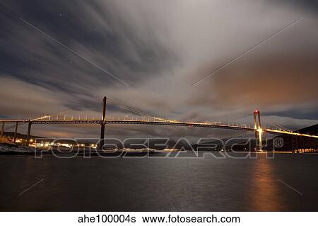 Stock Photograph - Dramatic sky over Tjeldsund Bridge in Troms County, Norway.. Fotosearch