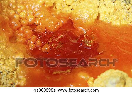 Stock Photograph - Droplets splashing in pool of molten sulphur, Kawah Ijen volcano, Java, Indonesia.. Fotosearch