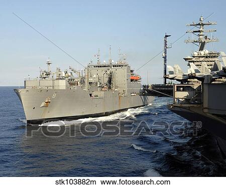 Dry cargo and ammunition ship USNS Wally Schirra transits alongside aircraft carrier USS Nimitz. View Large Photo Image Picture - Dry cargo and ammunition ship USNS Wally Schirra transits alongside aircraft carrier USS Nimitz.. Fotosearch