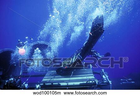Dry Deck Shelter rewmen release the hold down straps from an inflating Combat Rubber Raiding Craft. View Large Photo Image Picture - Dry Deck Shelter rewmen release the hold down straps from an inflating Combat Rubber Raiding Craft.. Fotosearch