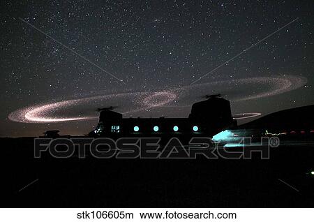 Dust lights up the rotors of a CH-47 Chinook helicopter. View Large Photo Image Picture - Dust lights up the rotors of a CH-47 Chinook helicopter.. Fotosearch