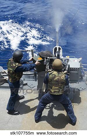 Electronics Technician fires a 25mm machine gun aboard USS Preble. View Large Photo Image Picture - Electronics Technician fires a 25mm machine gun aboard USS Preble.. Fotosearch