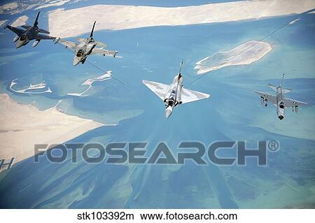 Emirati F-16's, an Emirati Mirage 2000, and a Pakistani F-7 fly in formation during a multinational exercise. View Large Photo Image Picture - Emirati F-16's, an Emirati Mirage 2000, and a Pakistani F-7 fly in formation during a multinational exercise.. Fotosearch