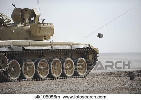 Empty casings eject from an Iraqi T-72 tank on the firing range. View Large Photo Image Picture - Empty casings eject from an Iraqi T-72 tank on the firing range.. Fotosearch