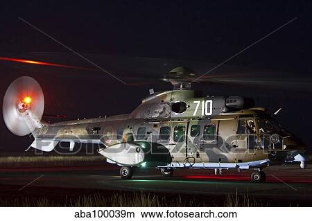 Picture - Eurocopter AS-532AL Cougar sits ready for a night flight.. Fotosearch