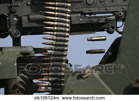 Expended brass falls from a machine gun. View Large Photo Image Picture - Expended brass falls from a machine gun.. Fotosearch