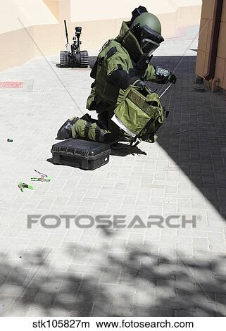 Picture - Explosive ordnance disposal technician investigates an IED.. Fotosearch