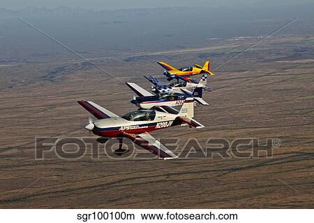 Picture - Extra 300 aerobatic aircraft fly in formation over Mesa, Arizona.. Fotosearch