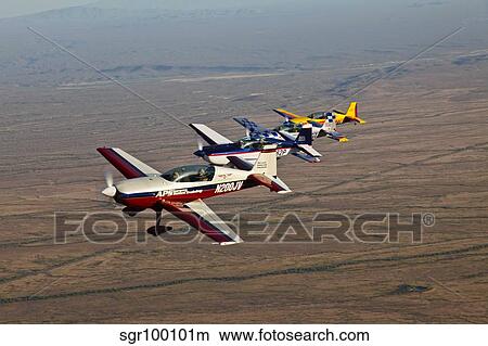 Extra 300 aerobatic aircraft fly in formation over Mesa, Arizona. View Large Photo Image Picture - Extra 300 aerobatic aircraft fly in formation over Mesa, Arizona.. Fotosearch