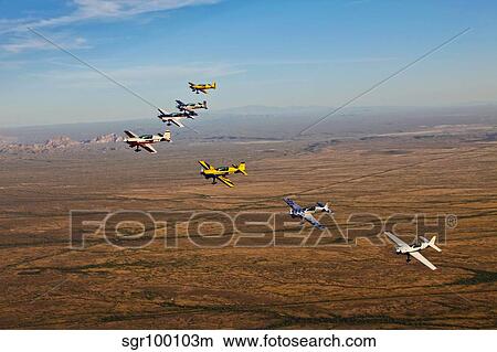 Extra 300 aerobatic aircraft fly in formation over Mesa, Arizona. View Large Photo Image Picture - Extra 300 aerobatic aircraft fly in formation over Mesa, Arizona.. Fotosearch