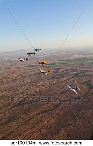 Picture - Extra 300 aerobatic aircraft fly in formation over Mesa, Arizona.. Fotosearch