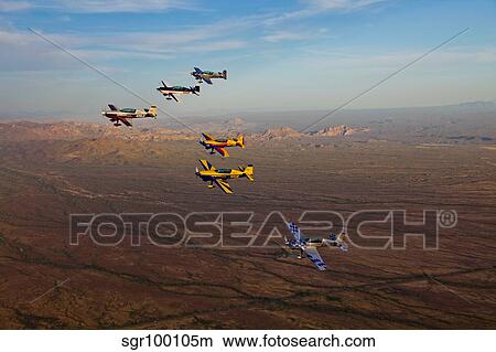 Extra 300 aerobatic aircraft fly in formation over Mesa, Arizona. View Large Photo Image Picture - Extra 300 aerobatic aircraft fly in formation over Mesa, Arizona.. Fotosearch