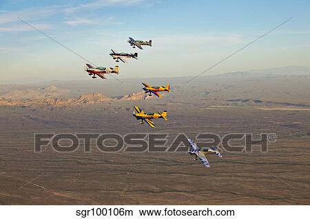 Extra 300 aerobatic aircraft fly in formation over Mesa, Arizona. View Large Photo Image Picture - Extra 300 aerobatic aircraft fly in formation over Mesa, Arizona.. Fotosearch