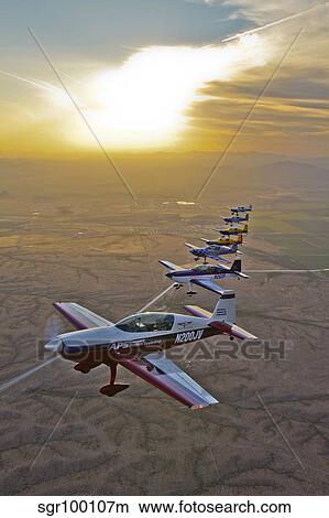 Extra 300 aerobatic aircraft fly in formation over Mesa, Arizona. View Large Photo Image Picture - Extra 300 aerobatic aircraft fly in formation over Mesa, Arizona.. Fotosearch