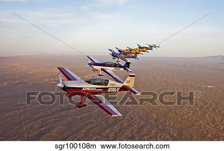 Picture - Extra 300 aerobatic aircraft fly in formation over Mesa, Arizona.. Fotosearch